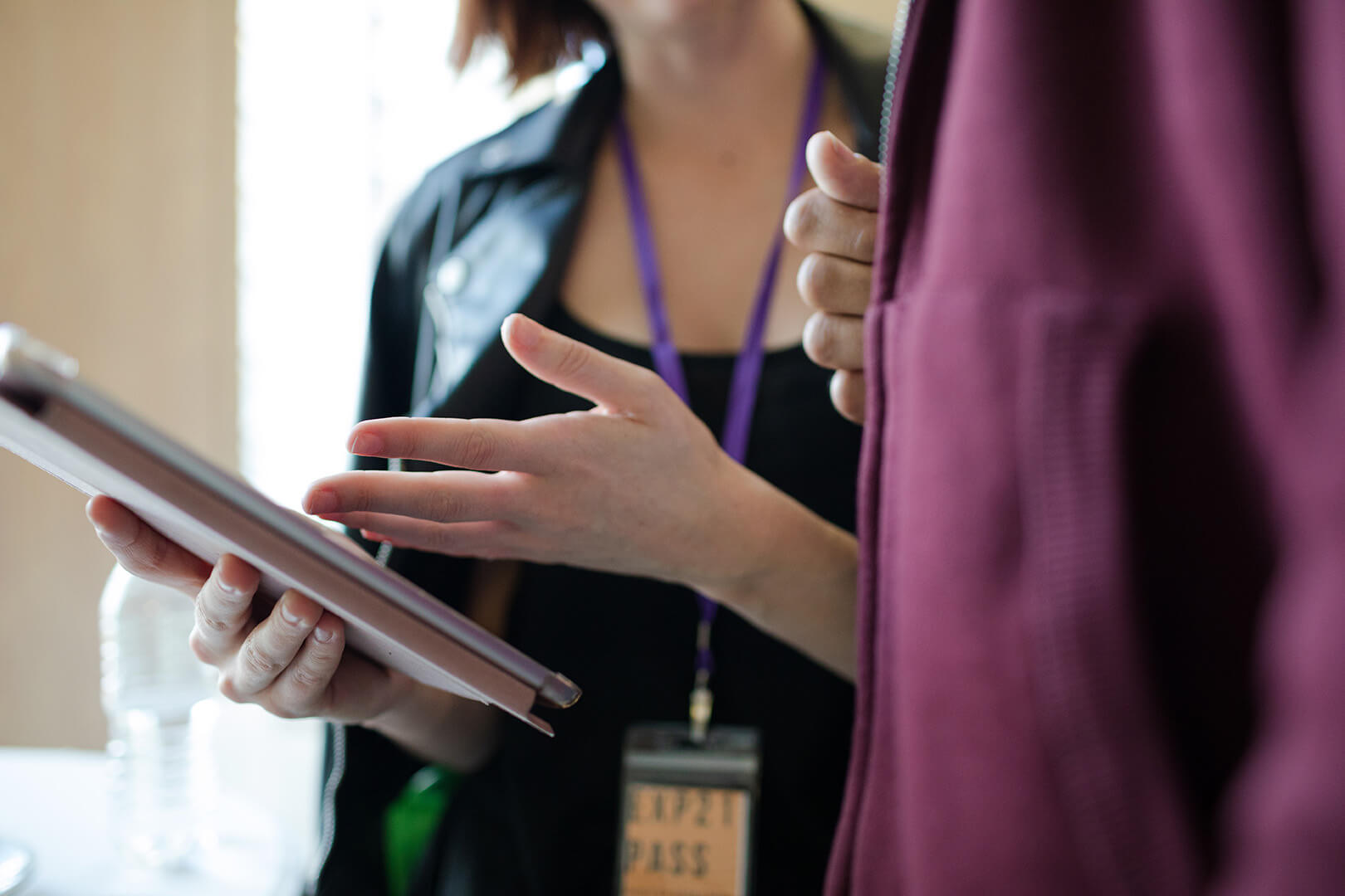 Man and woman using digital tablet during conference break